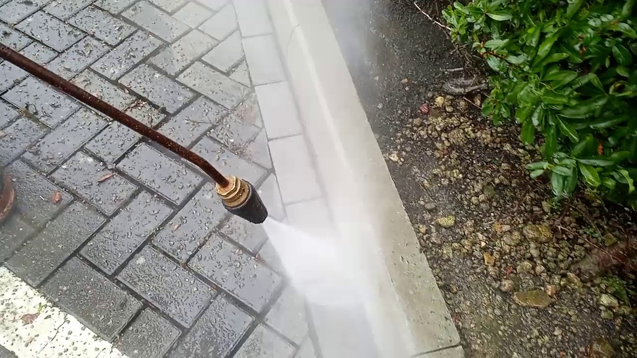 Cleaning a block paving driveway with high pressure washing